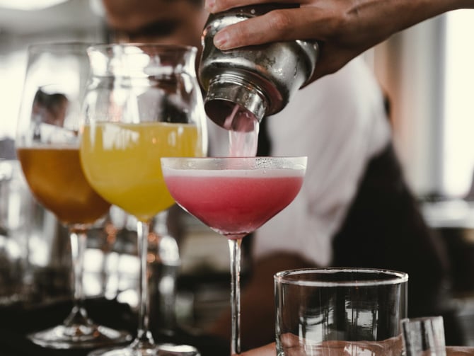 Bartender pouring cocktails for guests